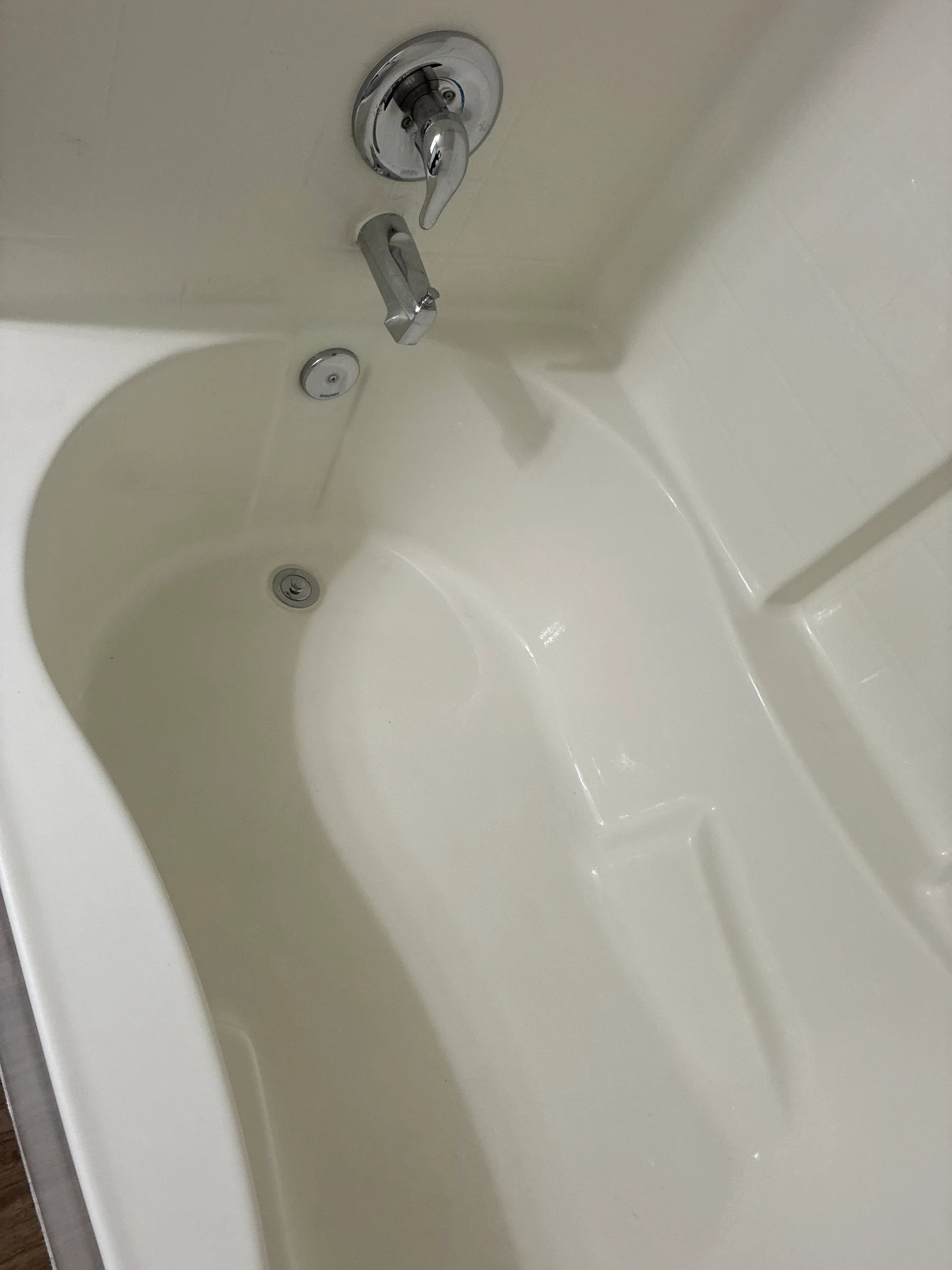 Bathtub before cleaning, with buildup and grime