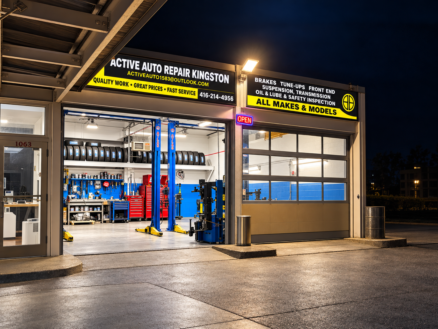 Active Auto Repair Kingston with its signs and open bay at night