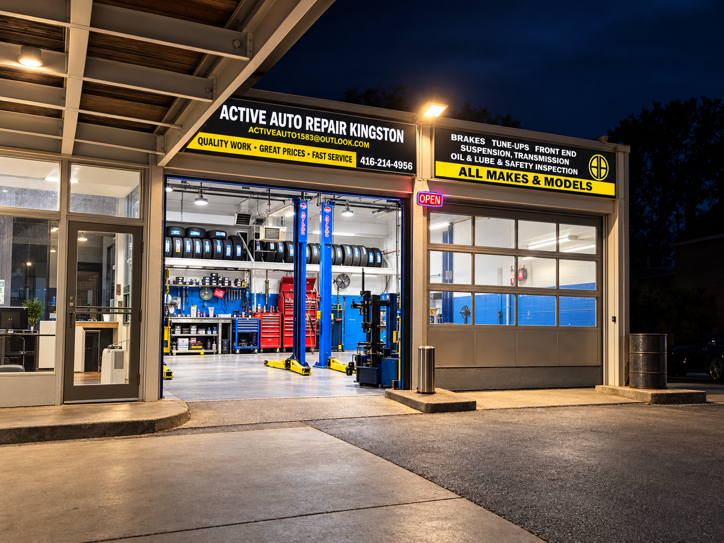 Inside the bay: two blue lifts, a tire machine and shelves of tires